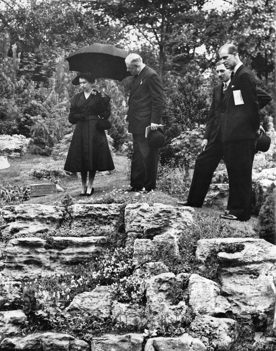 Queen Elizabeth II and Prince Philip (far right) admiring the rock garden at the Chelsea Flower Show, London, 20th May 1952. The garden was designed by Winkfield Manor Nurseries of Ascot. (Photo by George W. Hales/Fox Photos/Hulton Archive/Getty Images)