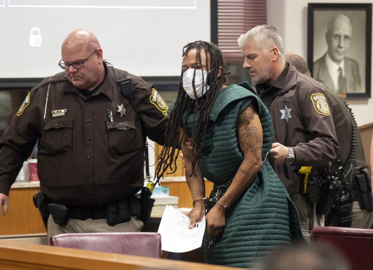 Darrell Brooks, center, is escorted out of the courtroom after making his initial appearance, Tuesday, Nov. 23, 2021 in Waukesha County Court in Waukesha, Wis. 