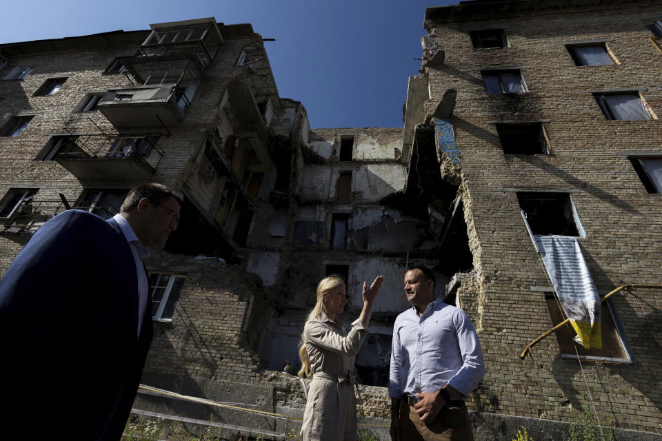 Ireland's Prime Minister Leo Varadkar, right, checks destroyed buildings in Moschun, outside of Kyiv, Ukraine, Wednesday July 19, 2023. (Clodagh Kilcoyne/Pool via AP)