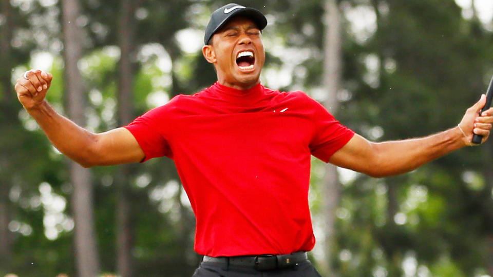 Tiger Woods celebrates after sinking his winning putt . (Photo by Kevin C. Cox/Getty Images)