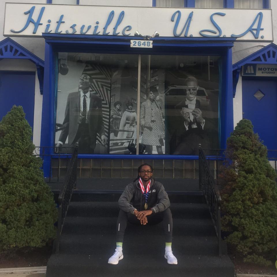 Rufaro Huggins sits on steps after completing a marathon in Detroit.