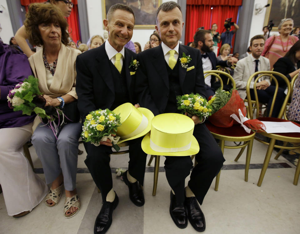 FILE - In this May 21, 2015 file photo, Angelo Albanesi, left, and Pier Giorgio De Simone wait for their civil union to be registered by a municipality officer during a ceremony in Rome's Campidoglio Capitol Hill. Pope Francis endorsed same-sex civil unions for the first time as pope while being interviewed for the feature-length documentary “Francesco,” which premiered Wednesday, Oct. 21, 2020 at the Rome Film Festival. (AP Photo/Gregorio Borgia, file)