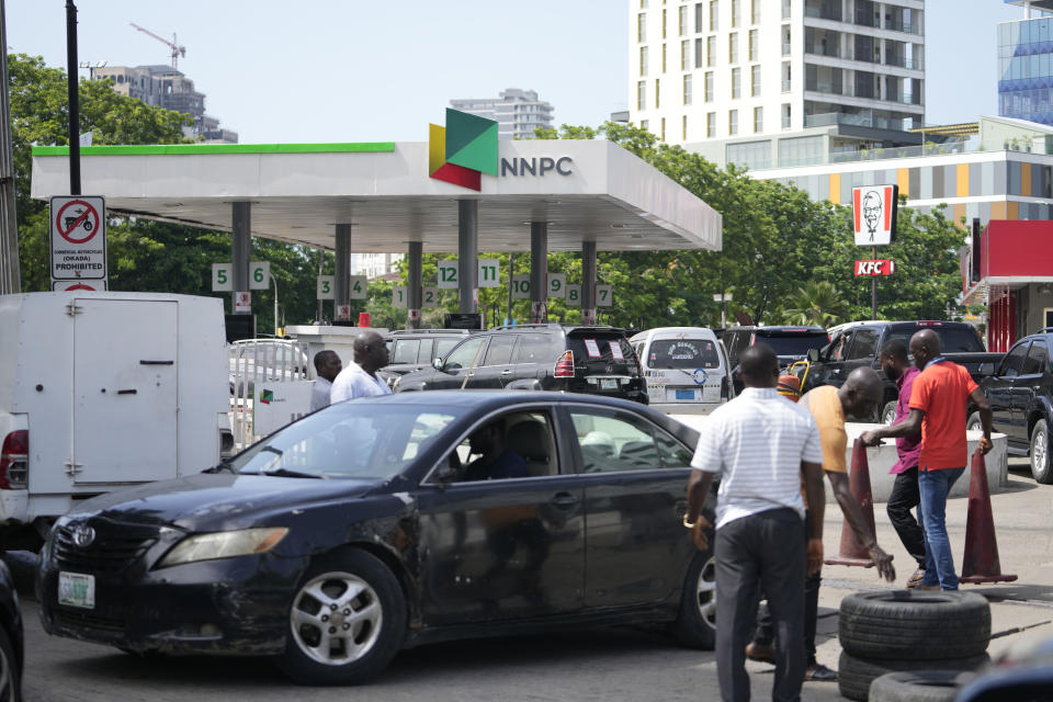 Motorists queue to buy fuel at a petrol station in Lagos, Nigeria, Tuesday, May 30, 2023. Nigerian President Bola Tinubu has scrapped a decadeslong government-funded subsidy that has helped reduce the price of gasoline, leading to long lines at fuel stations Tuesday as drivers scrambled to stock up before costs rise. (AP Photo/Sunday Alamba)