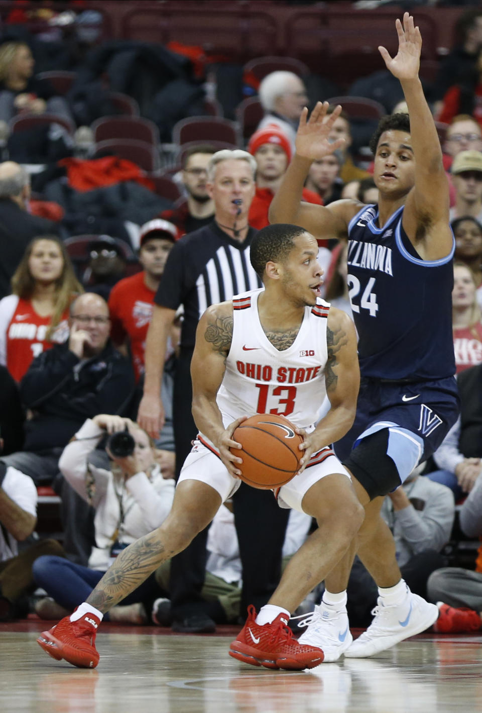 Ohio State's C.J. Walker, left, looks to pass the ball as Villanova's Jeremiah Robinson-Earl defends during the first half of an NCAA college basketball game Wednesday, Nov. 13, 2019, in Columbus, Ohio. (AP Photo/Jay LaPrete)