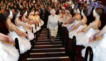 <p>Queen Elizabeth ascends a staircase lined with ballerinas while visiting the Royal Albert Hall in 2004.</p>