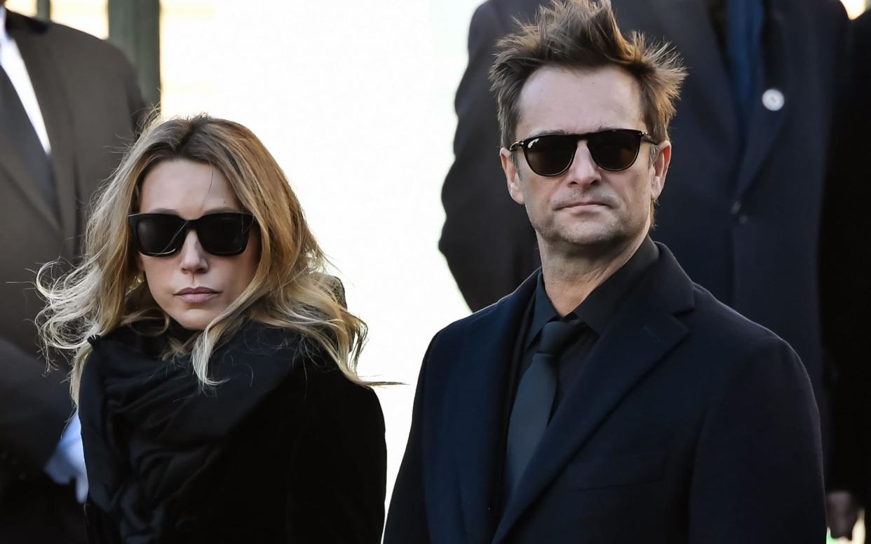 Written out: David Hallyday and Laura Smet stand outside La Madeleine Church after their father's funeral - AFP