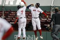 Boston Red Sox's Christian Vazquez, left, celebrates his three-run home run that also drove in Xander Bogaerts, right, during the sixth inning of a baseball game against the Baltimore Orioles, Tuesday, Sept. 22, 2020, in Boston. (AP Photo/Michael Dwyer)