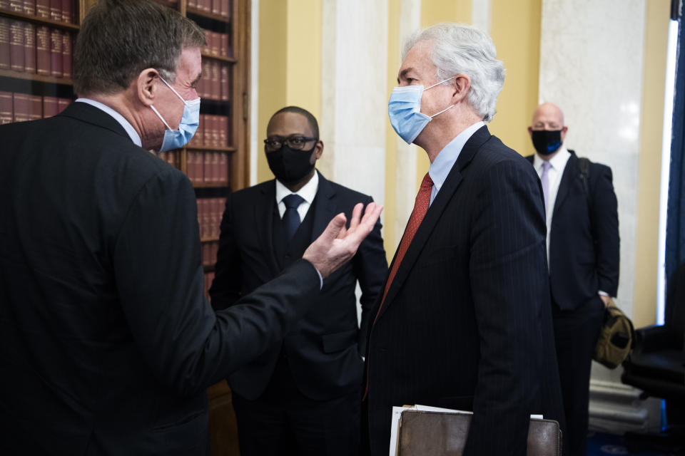 William Burns, nominee for Central Intelligence Agency director, talks with Chairman Mark Warner, D-Va., after his Senate Select Intelligence Committee confirmation hearing, Wednesday, Feb. 24, 2021, on Capitol Hill in Washington. (Tom Williams/Pool via AP)