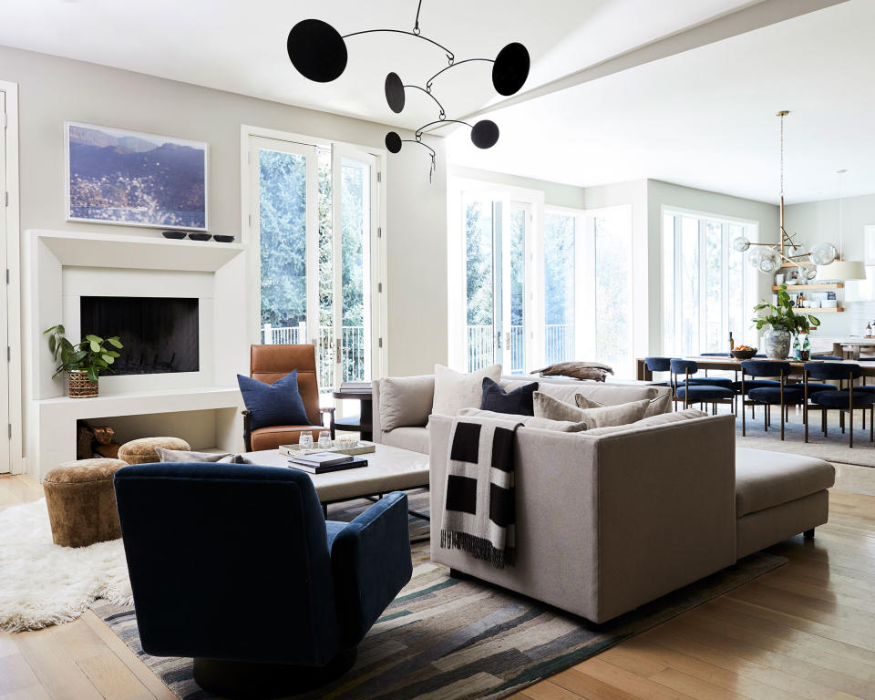 small living room with white walls and gray sofa with wood floor