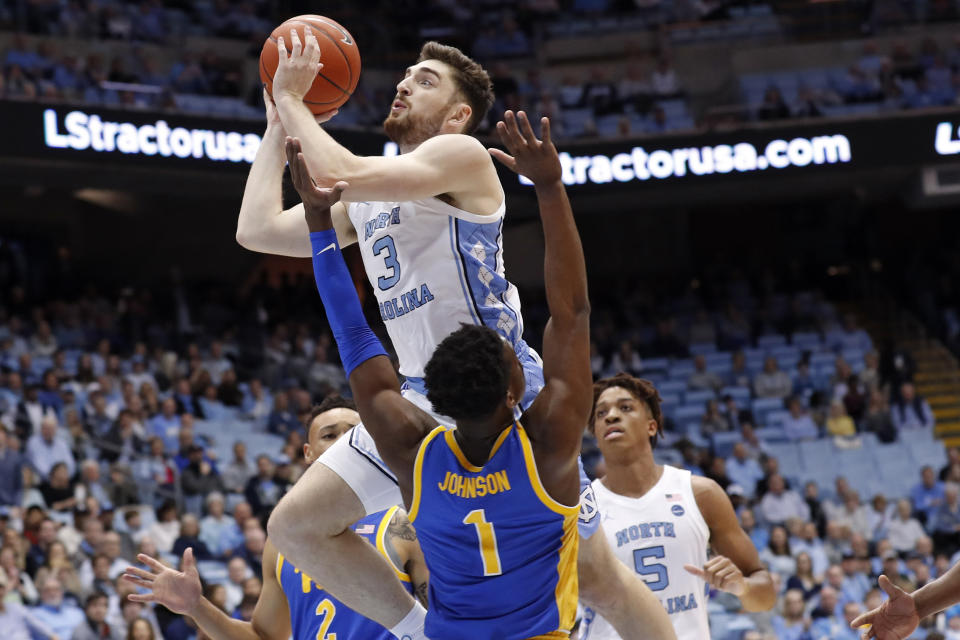 North Carolina guard Andrew Platek (3) shoots over Pittsburgh guard Xavier Johnson (1) during the first half of an NCAA college basketball game in Chapel Hill, N.C., Wednesday, Jan. 8, 2020. (AP Photo/Gerry Broome)