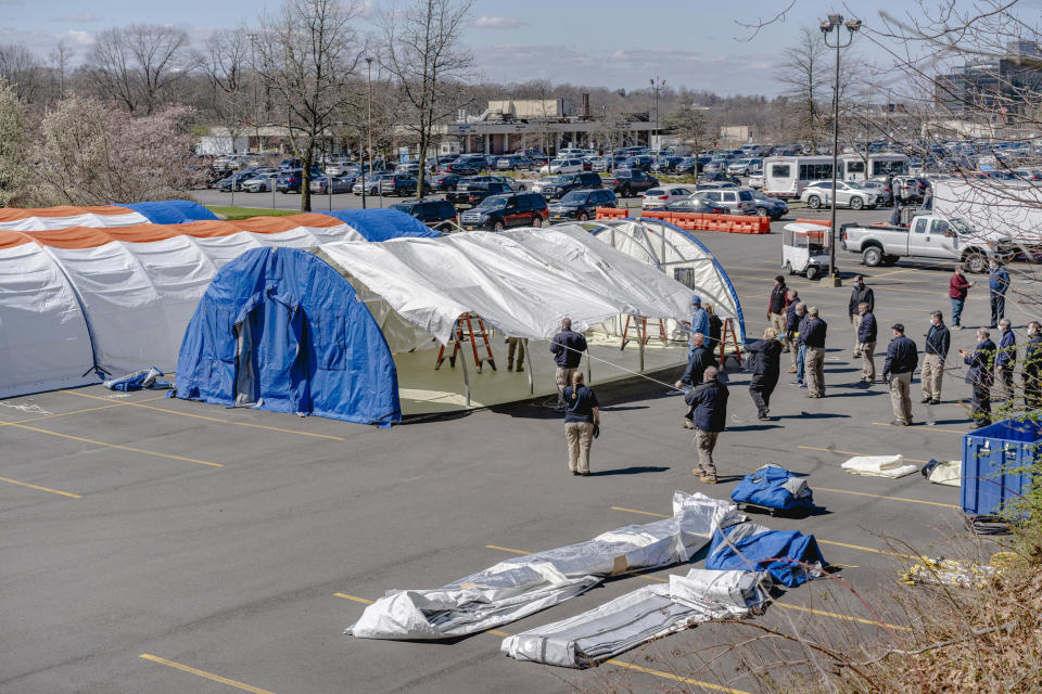 Image: Emergency tents are assembled in the parking lot of the North Shore University Hospital in Manhasset, N.Y., April 1, 2020. (Johnny Milano/The New York Times) (Johnny Milano / The New York Times via Redux)