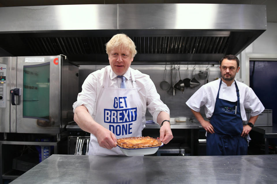 Prime Minister Boris Johnson holds a freshly bakes pie during a visit to the Red Olive in Derby, while on the General Election campaign trail.