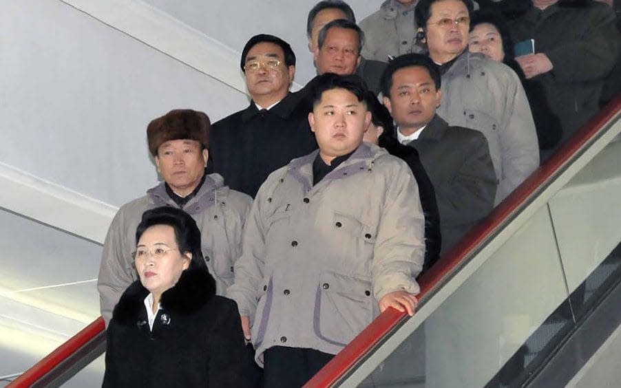 Kim Jong-un, second row right, rides on an escalator with his aunt Kim Kyong-hui, bottom, her husband Jang Song-thaek, second man behind Kim Jong-un in 2012 - AP