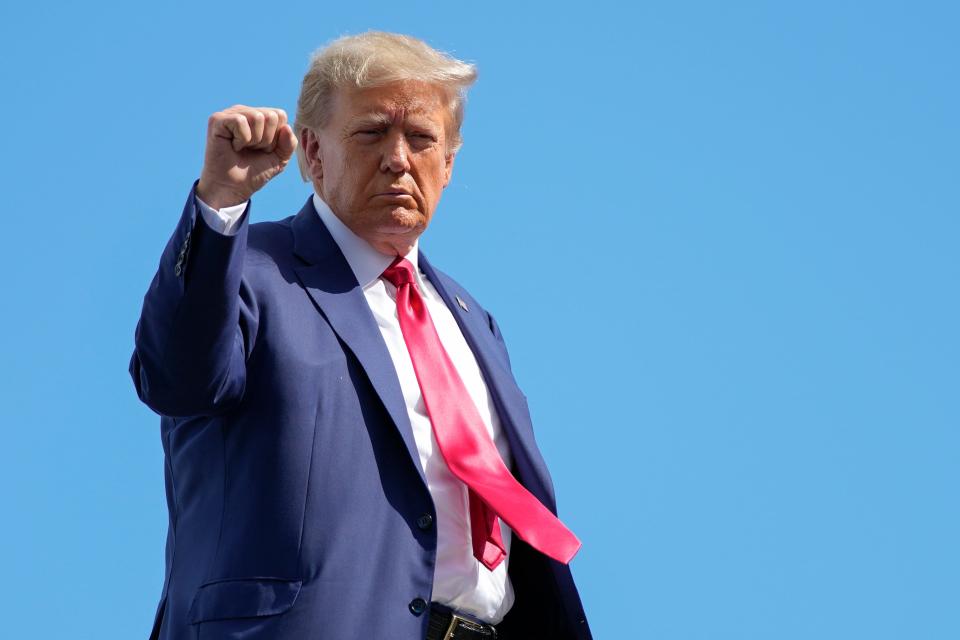 Former President Donald Trump gestures before boarding his personal plane at Miami International Airport, Tuesday, June 13, 2023, in Miami. Trump appeared in federal court Tuesday on dozens of felony charges accusing him of illegally hoarding classified documents and thwarting the Justice Department's efforts to get the records back.