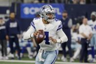 Dallas Cowboys quarterback Dak Prescott (4) scrambles before throwing a pass in the first half of an NFL football game against the Las Vegas Raiders in Arlington, Texas, Thursday, Nov. 25, 2021. (AP Photo/Michael Ainsworth)