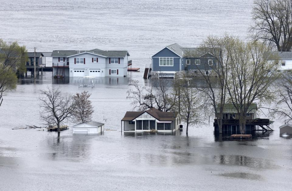 FILE - The flooded Mississippi River surrounds the homes on Abel Island near Guttenberg, Iowa, April 25, 2023. Diverting Mississippi River water to states struggling with water scarcity isn't a new idea. But mayors along the river may soon be voting to support a compact that could block such a diversion. (Stephen Gassman/Telegraph Herald via AP, File)