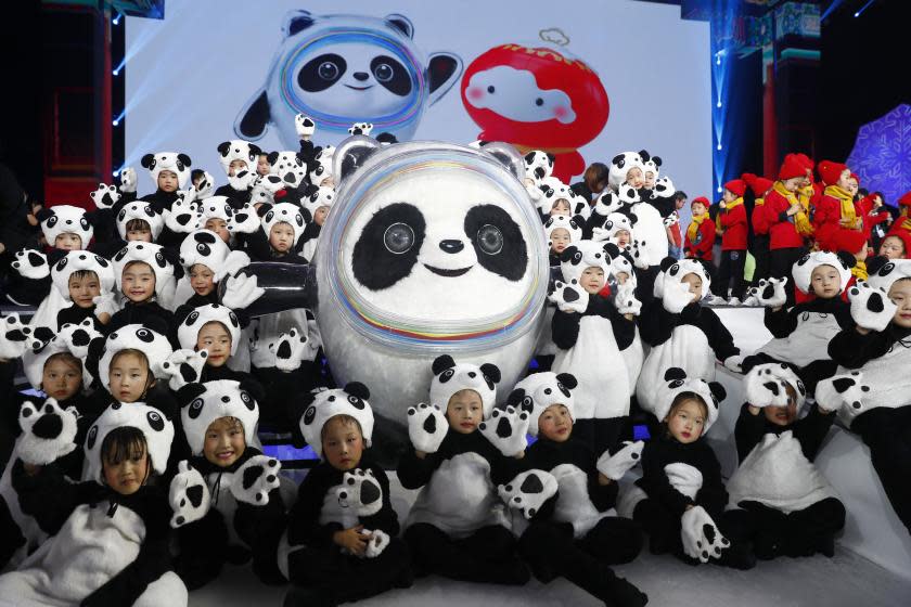 BEIJING, CHINA - SEPTEMBER 17: Children pose with the Mascot of the 2022 Olympic Winter Games, Bing Dwen Dwen, during a launching ceremony at the Shougang Ice Hockey Arena on September 17, 2019 in Beijing, China. (Photo by Fu Tian/China News Service/VCG via Getty Images)