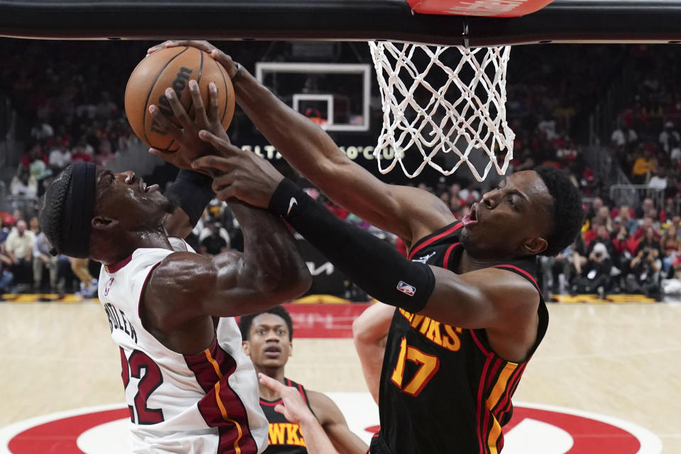 Miami Heat forward Jimmy Butler (22) has his shot blocked by Atlanta Hawks forward Onyeka Okongwu (17) in the first half of an NBA playoff basketball game Sunday, April 24, 2022, in Atlanta. (AP Photo/John Bazemore)