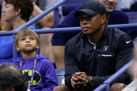 Tennis - US Open - Semifinals - New York, U.S. - September 8, 2017 - Golfer Tiger Woods sits with his son Charlie as they watch Rafael Nadal of Spain in action against Juan Martin del Potro of Argentina. REUTERS/Mike Segar