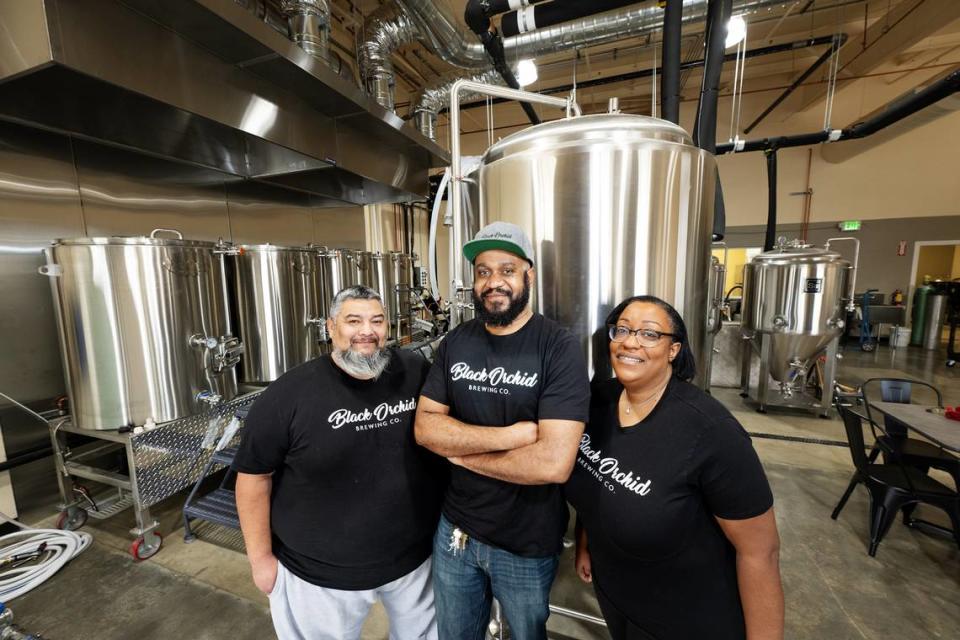 Black Orchid Brewing owners Joffre Roberts, middle, Tyanne Penado, right, and her husband Henry, left, at their new space on Sylvan Avenue in Modesto, Calif., Friday, Jan. 12, 2024.