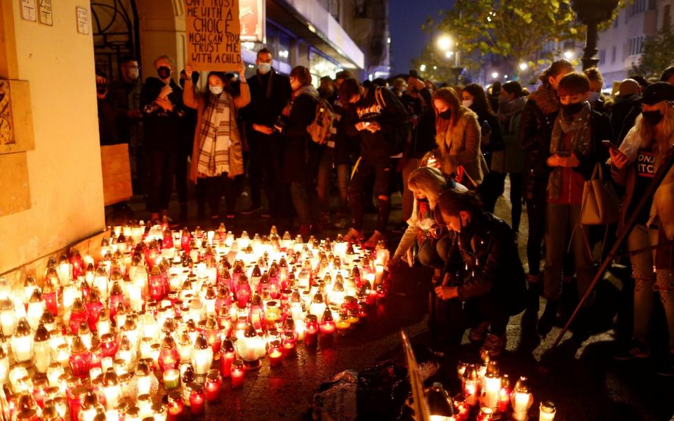 People lit candles outside the Law and Justice headquarters - Reuters