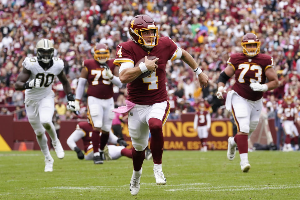 Washington Football Team quarterback Taylor Heinicke (4) rushes the ball in the first half of an NFL football game against the New Orleans Saints, Sunday, Oct. 10, 2021, in Landover, Md. (AP Photo/Alex Brandon)