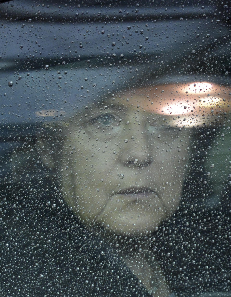 German Chancellor Angela Merkel looks out from behind raindrops on her car window as she arrives for an EU summit in Brussels on Friday, Nov. 23, 2012. The prospect of failure hangs over a European Union leaders’ summit intended to lay out the 27-country bloc’s long-term spending plans. While heavyweights like Britain and France are pulling in opposite directions, smaller members are threatening to veto a deal to make themselves heard. (AP Photo/Geert Vanden Wijngaert)