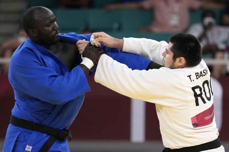 Mbagnick Ndiaye of Senegal, left, and Tamerlan Bashaev of the Russian Olympic Committee compete during their men's +100kg elimination round judo match at the 2020 Summer Olympics, Friday, July 30, 2021, in Tokyo, Japan. (AP Photo/Vincent Thian)