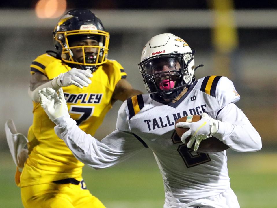 Tallmadge wide receiver Collin Dixon, right, rushes for yards ahead of Copley safety Glen Parker during the second half of a high school football game, Friday, Oct. 15, 2021, in Copley, Ohio.