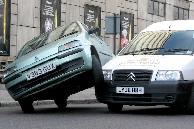 A car rests on top of a van, after a coming together in Victoria, London.