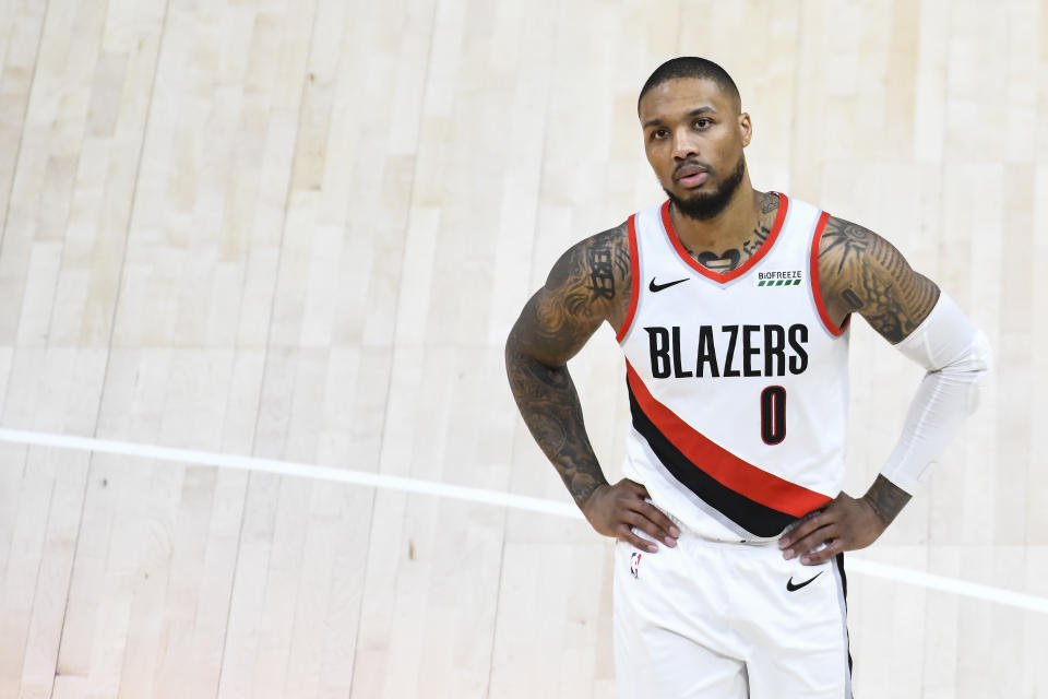 Damian Lillard with his hands on his hips during a Trail Blazers game.