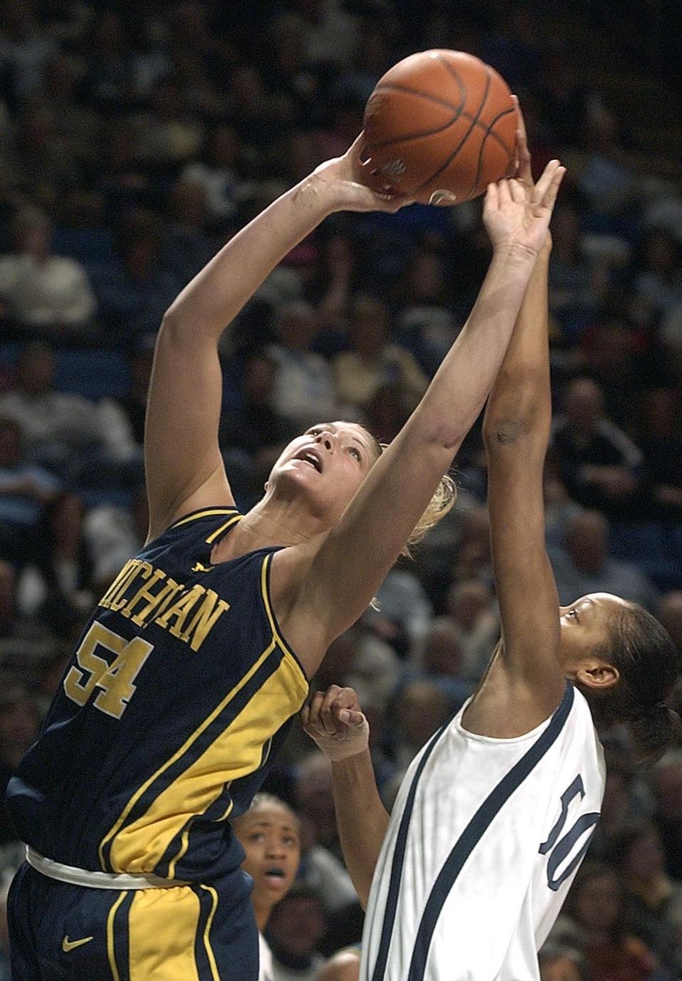 Michigan's Jennifer Smith (54) is fouled by Penn State's Reicina Russell (50) in the second half Sunday, Feb. 15, 2004, in State College, Pa. Penn State won 73-44. (AP Photo/Pat Little)