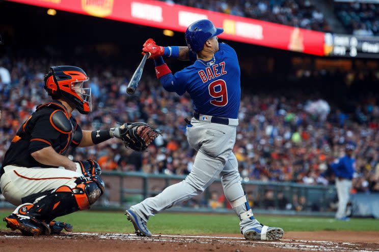 Javier Baez hits a pitch just inside the walls of AT&T Park, and his rapid sprint around the bases helped the Cubs go ahead by two runs in the second inning against the San Fransisco Giants (Getty Images).