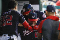 Washington Nationals' Brian Dozier, top back, gets a piggyback ride from Ali Modami as they celebrate Dozier's solo home run during the fourth inning of the team's baseball game against the Cincinnati Reds at Nationals Park, Tuesday, Aug. 13, 2019, in Washington. (AP Photo/Alex Brandon)