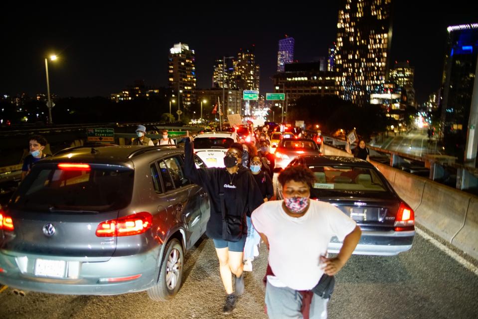 Protesters march across the Manhattan Bridge, Wednesday, Sept. 23, 2020, in New York, following a Kentucky grand jury's decision not to indict any police officers for the killing of Breonna Taylor. (AP Photo/Eduardo Munoz Alvarez)