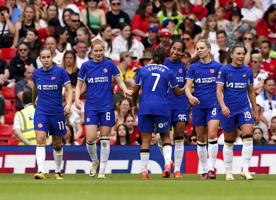 Chelsea's Mayra Ramirez, third right, celebrates with teammate Jess Carter after scoring their side's fourth goal of the game during the English Women's Super League soccer match between Manchester United and Chelsea at Old Trafford, in Manchester, England, Saturday May 18, 2024. (Martin Rickett/PA via AP)