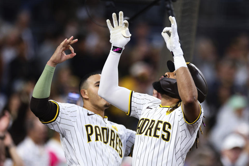 San Diego Padres' Fernando Tatis Jr., right, celebrates with Manny Machado after hitting a solo home run against the Milwaukee Brewers during the fifth inning of a baseball game Thursday, June 20, 2024, in San Diego. (AP Photo/Derrick Tuskan)