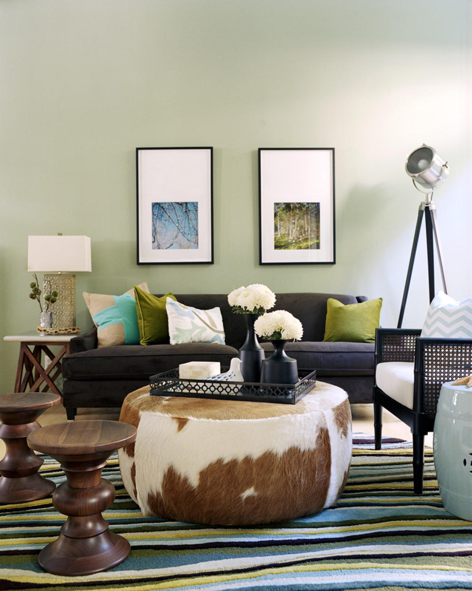 This undated photo provided by Kyle Schuneman shows party seating in a living room in a townhouse in Santa Monica, Calif. The cowhide ottoman functions normally as a coffee table but for parties the tray is removed for extra seating. The two Eames stools work well for impromtu seating and garden stool next to the chair can be used either as a seat or surface for drinks. (AP Photo/Kyle Schuneman, Joe Schmelzer)