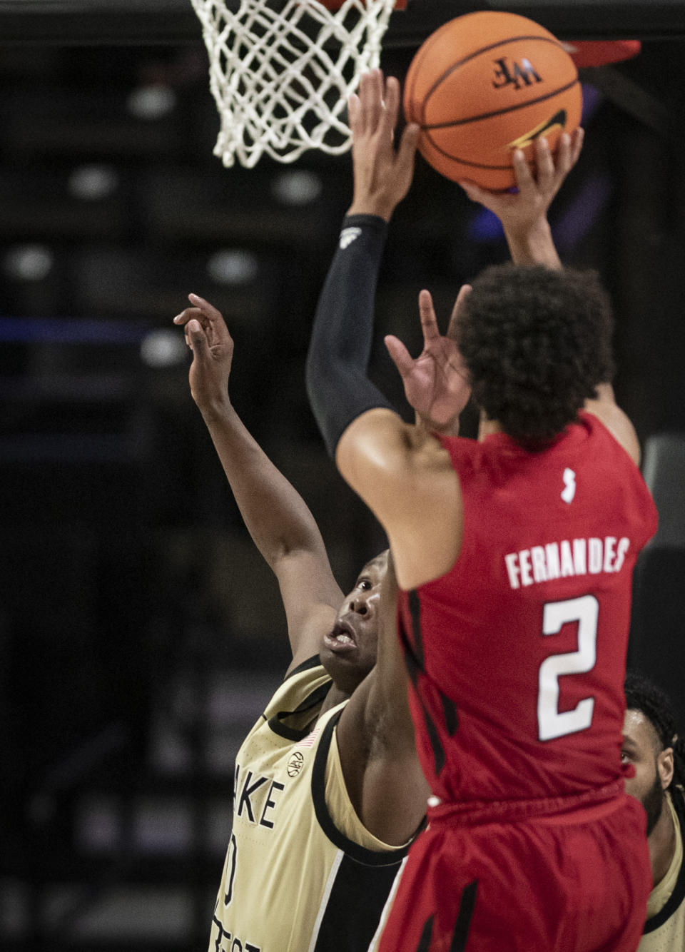 Rutgers guard Noah Fernandes (2) shoots over Wake Forest guard Kevin Miller (0) during the first half of an NCAA college basketball game Wednesday, Dec. 6, 2023, in Winston-Salem, N.C. (Allison Lee Isley/The Winston-Salem Journal via AP)