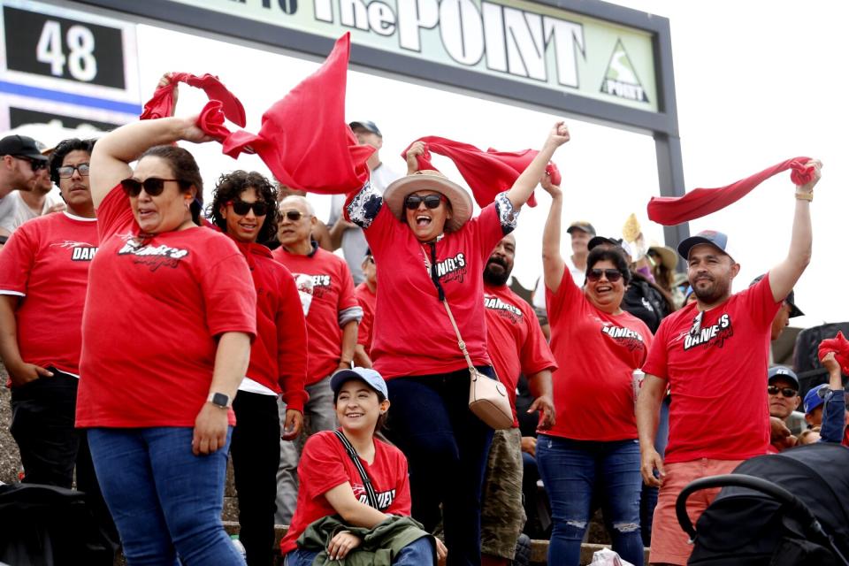 Members of "Daniel's Amigos" group cheer for NASCAR driver Daniel Suárez at Sonoma Raceway.