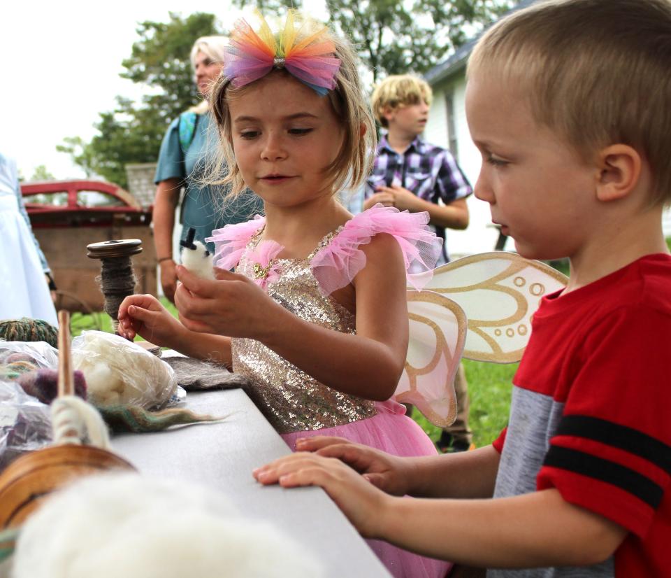 Members of the Homeschool Wayfinders Community, Victoria Romano, 6, (left) and her brother, Dougie, 5, learn about different types of wool.