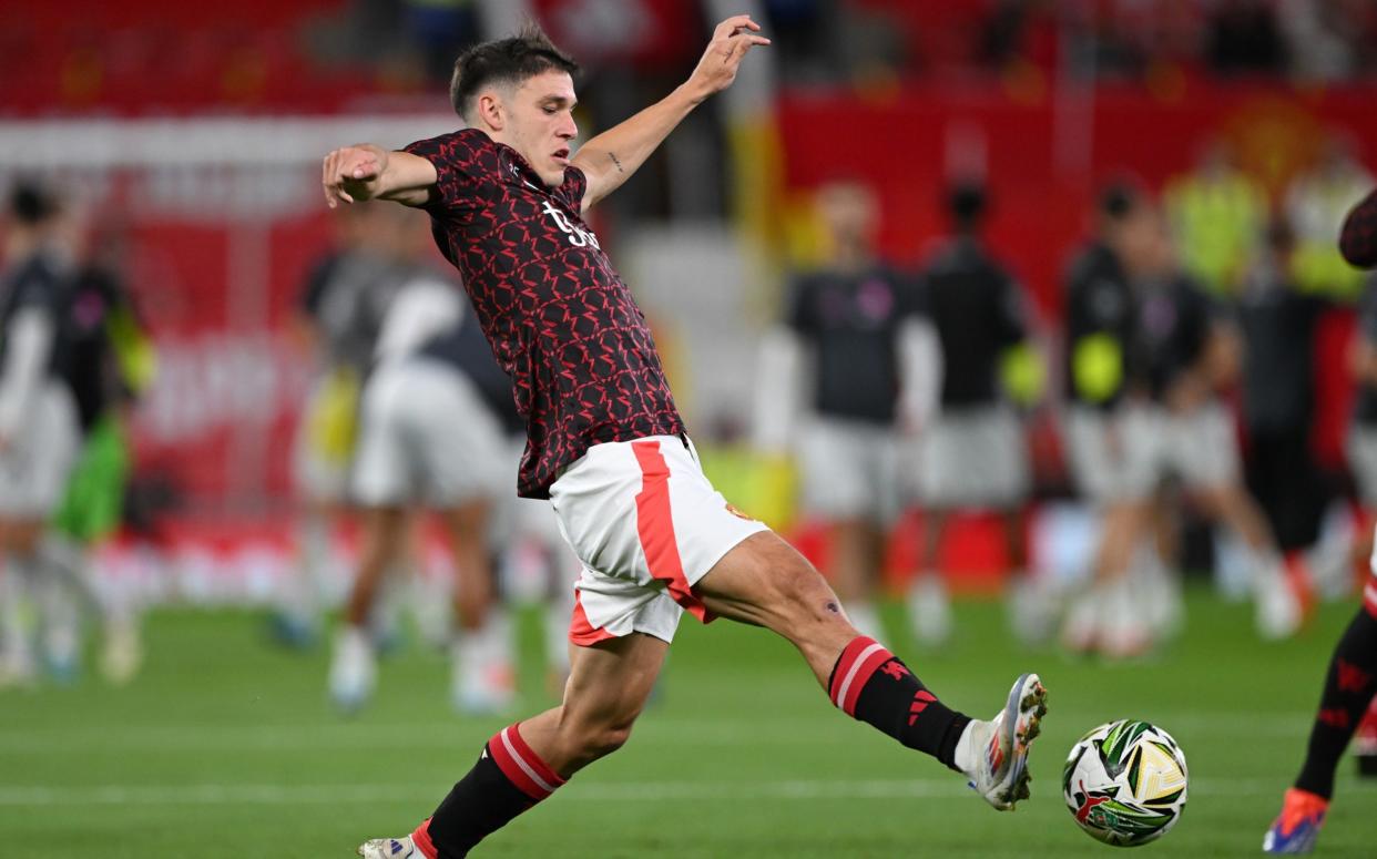 Manuel Ugarte warms up prior to the Carabao Cup Third Round match between Manchester United and Barnsley at Old Trafford on September 17, 2024