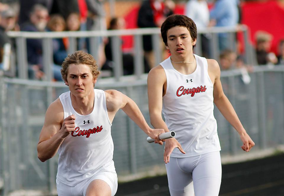 Crestview's Adison Reymer takes the handoff from Gabe Smedley as they compete in the 4x200 meter relay during the Forest Pruner Track Invitational at Crestview High School on Friday, April 22, 2022. TOM E. PUSKAR/TIMES-GAZETTE.COM