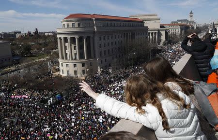 Spectators look down from the balcony of the Newseum building as students and gun control advocates hold the "March for Our Lives" event demanding gun control after recent school shootings at a rally in Washington, U.S., March 24, 2018. REUTERS/Leah Millis