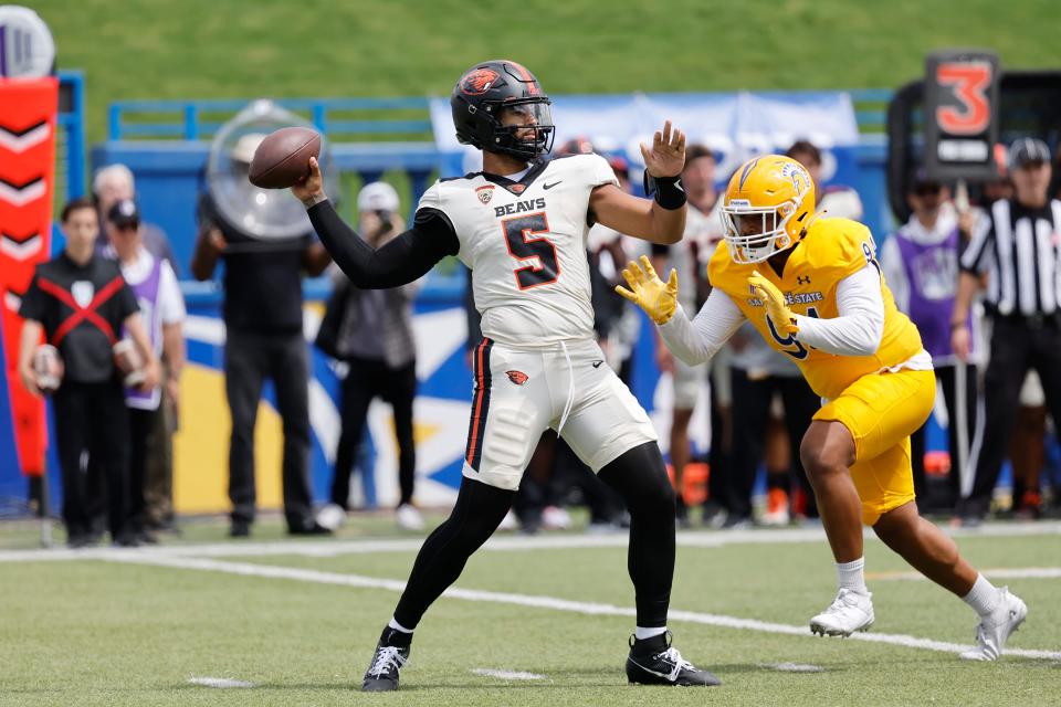 Oregon State quarterback DJ Uiagalelei (5) throws the ball as San Jose State defensive lineman Mata Hola (94) approaches in the first half, Sunday, Sept. 3, 2023.