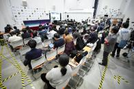 Members of the media watch a preview of the pinpoint moon landing operation by the Smart Lander for Investigating Moon (SLIM) spacecraft at Japan Aerospace Exploration Agency (JAXA) Sagamihara Campus Friday, Jan. 19, 2024, in Sagamihara near Tokyo. (AP Photo/Eugene Hoshiko)
