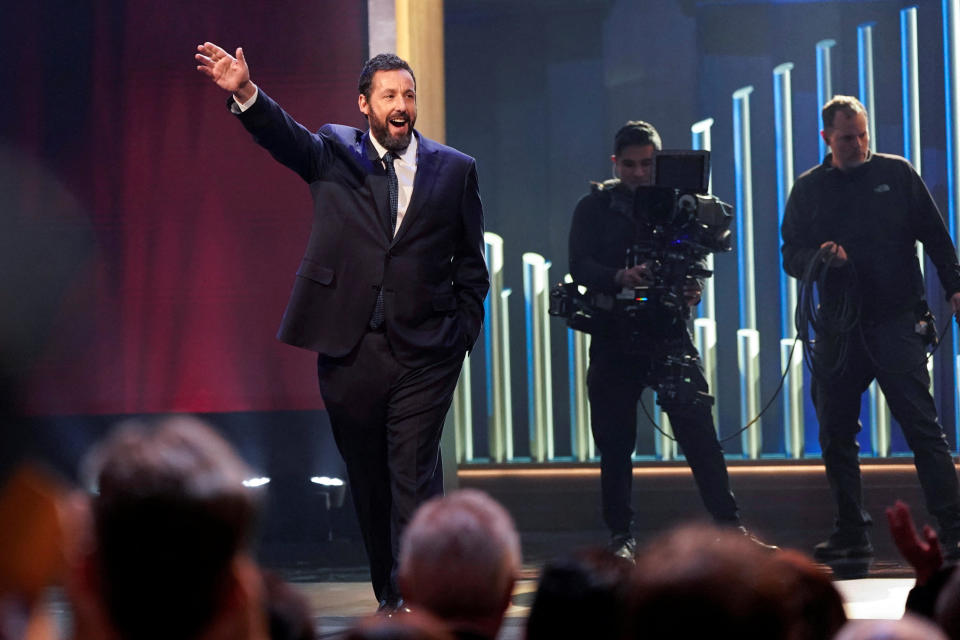 Actor and comedian Adam Sandler waves as he is awarded the Mark Twain Prize for American Humor at the Kennedy Center in Washington.  / Credit: JOSHUA ROBERTS / REUTERS