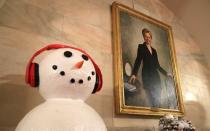 A photo of former Secretary of State and First Lady, Hilary Clinton, hangs near snowmen decorations in the Center Hall.