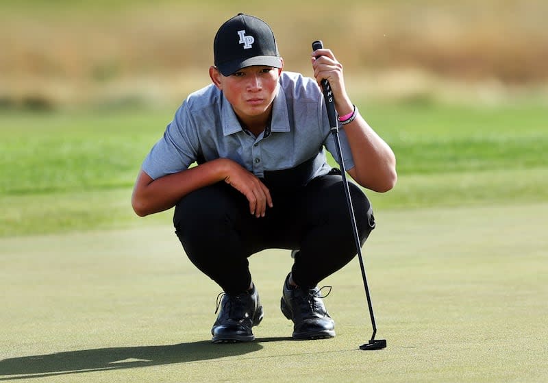 Lone Peak’s Kihei Akina eyes the hole as he competes in the 6A boys golf championships at TalonsCove in Saratoga Springs.