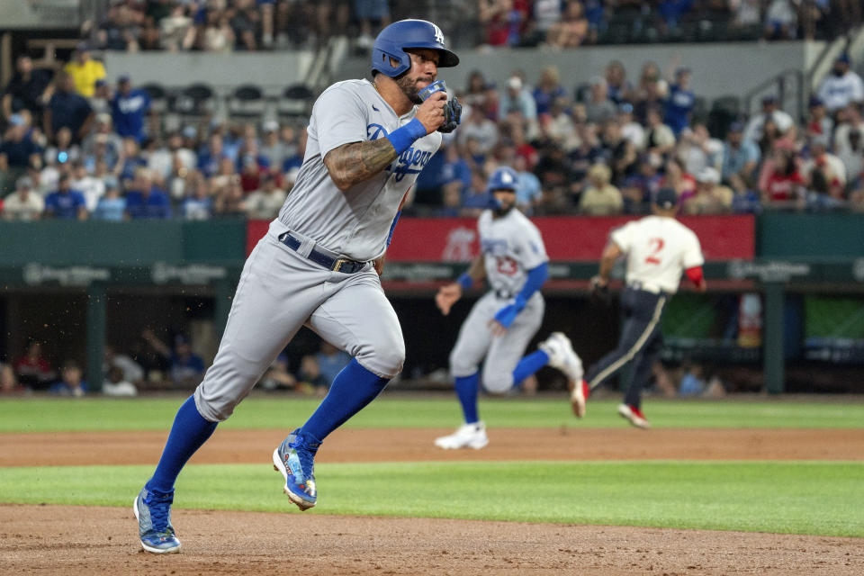 Los Angeles Dodgers' David Peralta advances to third on a single by James Outman during the second inning of a baseball game against the Texas Rangers, Saturday, July 22, 2023, in Arlington, Texas. (AP Photo/Jeffrey McWhorter)